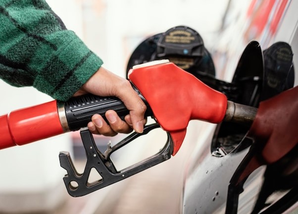 A person pumping gas into their car.