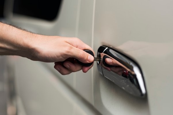 A person opening the door of a car